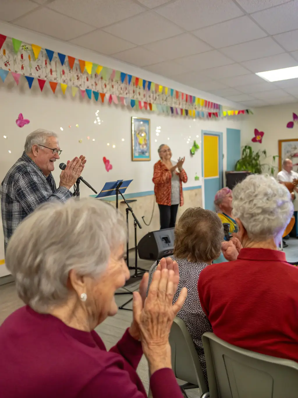 A heartwarming scene from a concert in a local nursing home, with musicians playing for elderly residents and creating a joyful atmosphere.
